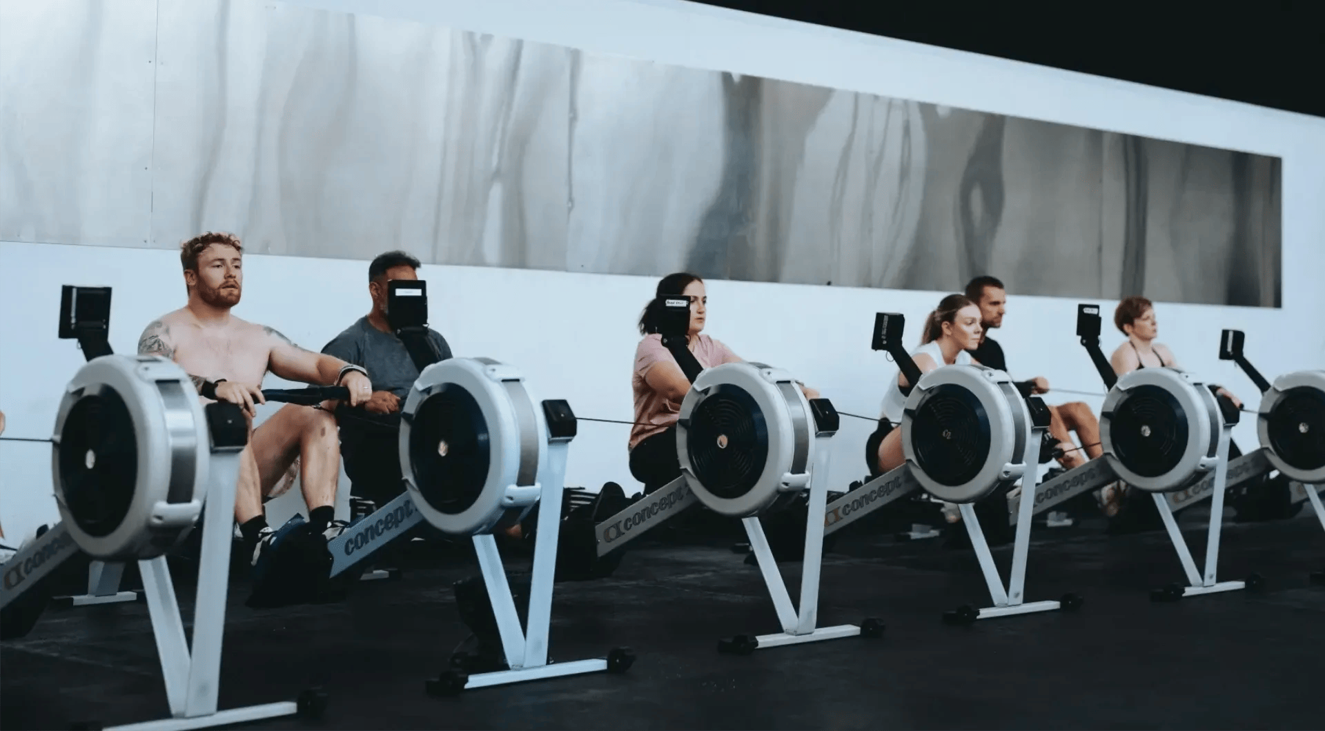 people rowing for HYROX training